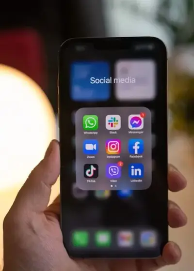 Phone showing social media apps: Instagram, TikTok, YouTube and X