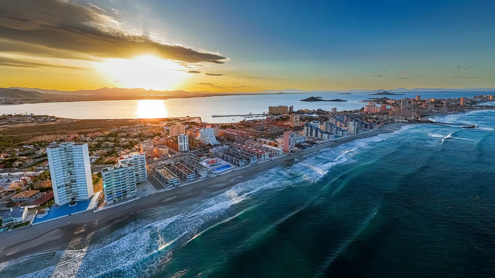 Vista aérea al atardecer del cordón de La Manga del Mar Menor entre el Mar Menor y el Mediterráneo