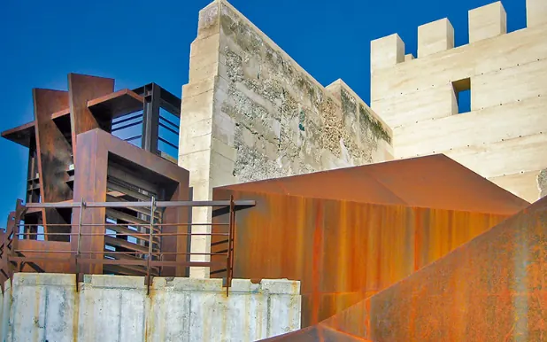 Molina de Segura castle with the weathering steel walkways from its restoration, a local landmark in the Vega Media where Inteclia works with small businesses